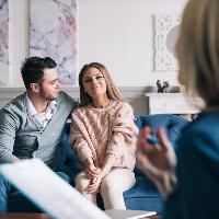 couple smiling and happy in counselling session